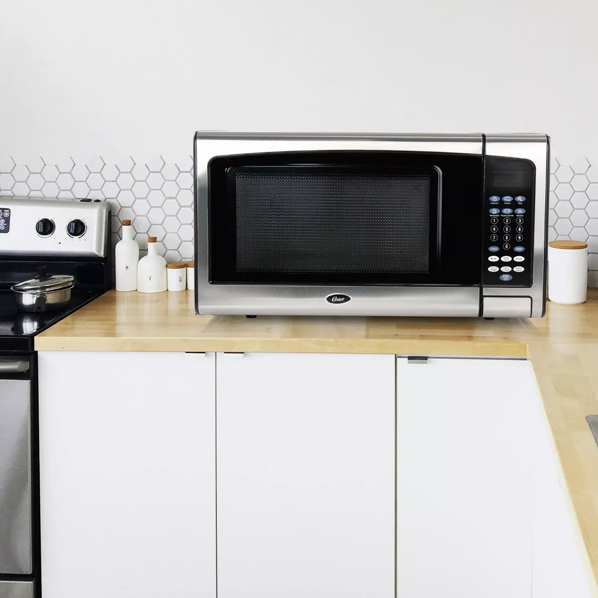 Oster 1.1 CuFt Digital Microwave Oven in Black and Silver